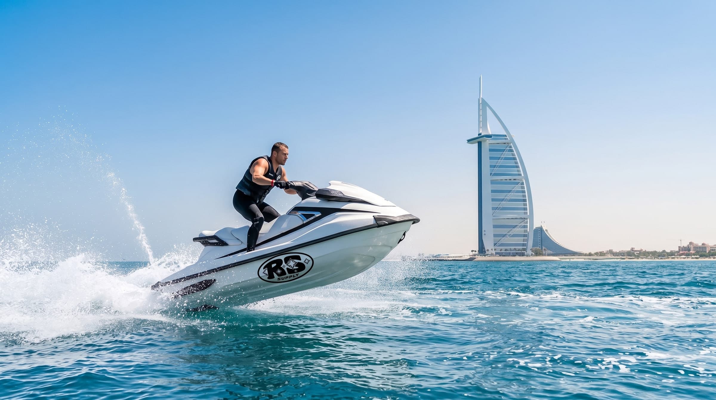 A rider lifting a jet ski off the water with the Burj Al Arab behind